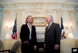 FILE - European Union's chief diplomat Federica Mogherini reacts to question from the media as she meets with U.S. Secretary of State Rex Tillerson.