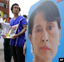 FILE - A Myanmar's activist holds a picture of their leader Aung San Suu Kyi during a rally calling for the immediate release of their pro-democracy leader Aung San Suu Kyi and her colleagues near the Myanmar Embassy in Seoul, Aug. 8, 2010.