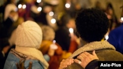 FILE - Community members gather during a candlelit vigil in support of legislation for child victims of human trafficking, Dec. 11, 2014, in Atlanta. 