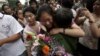 A Chinese student is greeted by a relative after attending the end of the annual college entrance examinations, in Beijing, China, Tuesday, June 8, 2010. Each year, about 10 million high school seniors across China take the "gaokao" -- the exam that is th