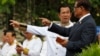 Cambodia's Prime Minister Hun Sen, second from right, talks with Sar Kheng, right, deputy prime minister and minister of Ministry of Interior, as they wait to attend the Independence Day celebrations in Phnom Penh, Cambodia, Thursday, Nov. 9, 2017. Some hundreds of civil servants and students gathered to mark the country's 64th Independence Day. The country gained independence from France on Nov. 9, 1953. (AP Photo/Heng Sinith)