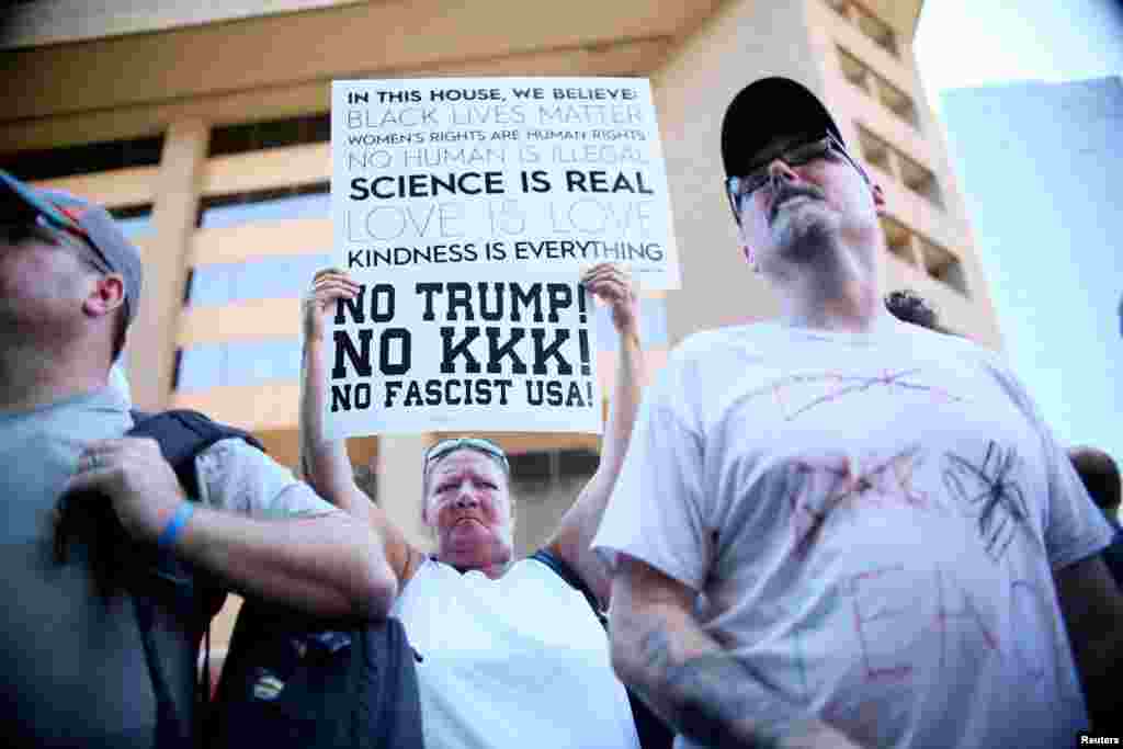 Pro Trump supporters face off with peace activists during protests outside a Donald Trump campaign rally in Phoenix, Ariz., Aug. 22, 2017.