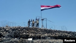   Syrian forces of President Bashar Al Assad are seen celebrating on al-Haara hill in the Quneitra region, recaptured rebels and IS militants on July 17, 2018. 
