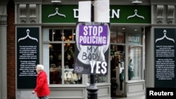 A woman walks past a pro-choice poster in the city center of Dublin, Ireland, May 22, 2018.