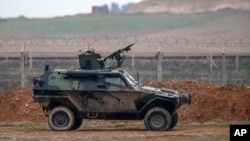FILE - A Turkish military vehicle is seen patrolling the Turkey-Syrian border near the Akcakale border crossing in Turkey, January 2015.