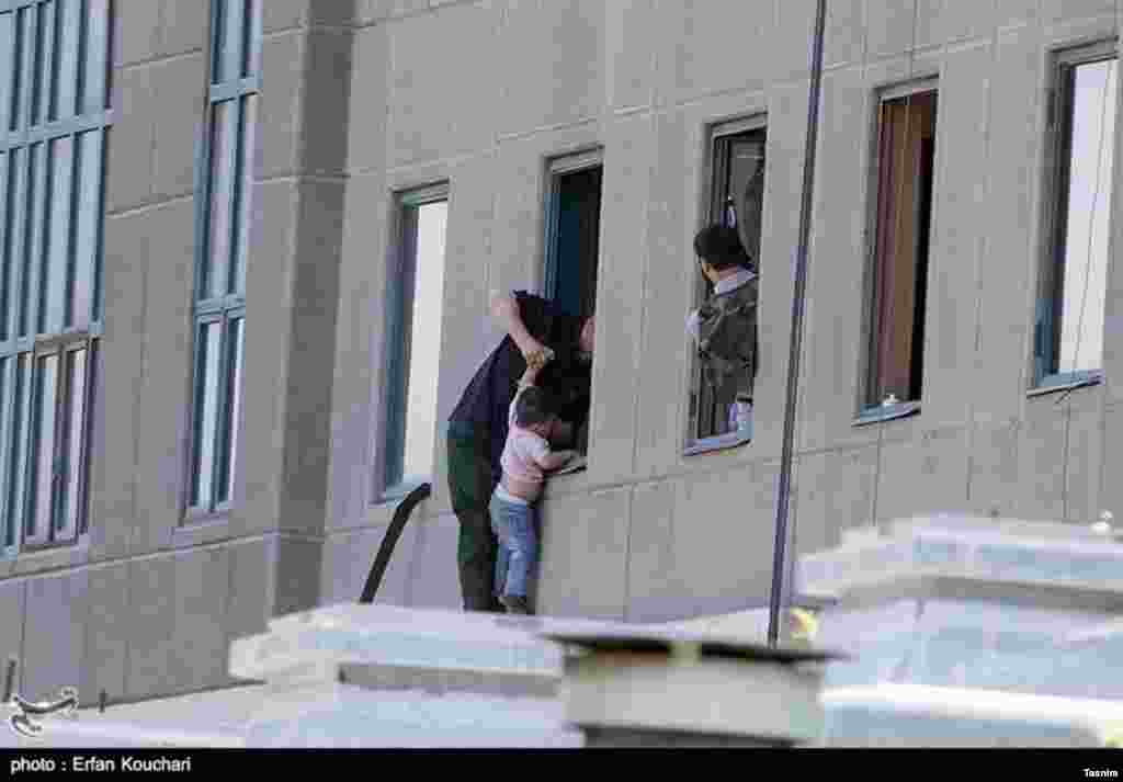 عکسی از حمله تروریستی در تهران - برخی گروگان ها از ساختمان ها بیرون فرار می کنند.
