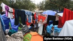 A child walks among laundry hung to dry after a rainstorm in the tent camp in Reynosa. (Dylan Baddour/VOA)