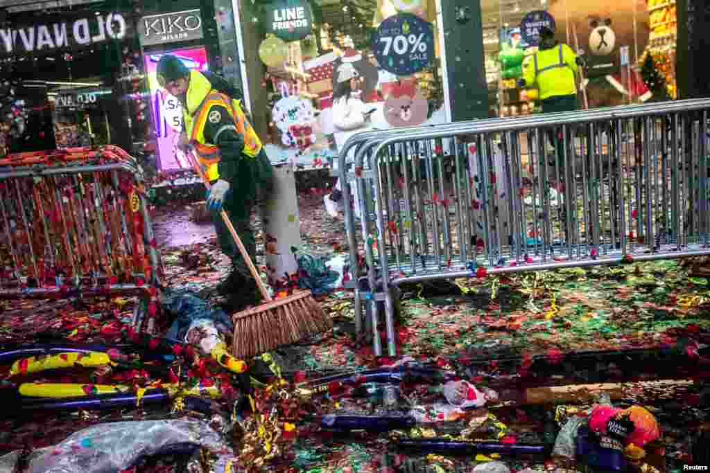 Workers clean up the area after New Year&#39;s Eve celebrations in Times Square in New York City.