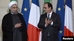 Le Président iranien Hassan Rouhani (G) et le président français François Hollande lors d'une cérémonie de signature à l'Elysée à Paris, France, 28 janvier 2016. (Photo REUTERS/Stephane De Sakutin)