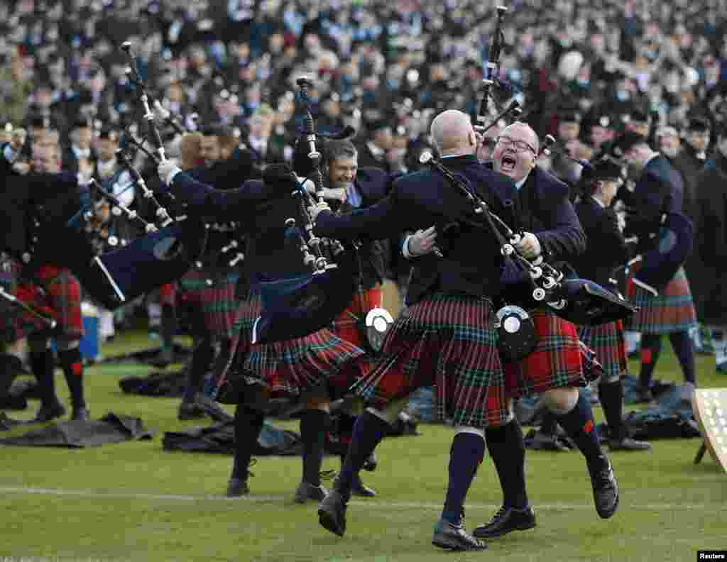 Members of the Field Marshall Montgomery Pipe Band react to winning the annual World Pipe Band Championships at Glasgow Green, Scotland, Aug. 16, 2014.