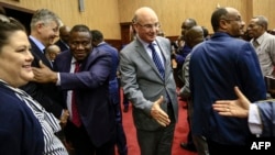 FILE - Jean-Pierre Lacroix, second left, U.N. undersecretary-general for peacekeeping, and Smail Chergui, center, AU commissioner for peace and security, greet delegates after initial peace talks between Central African Republic and armed groups in Khartoum, Sudan, Jan. 24, 2019.