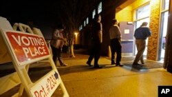 FILE - People line up to vote at a precinct in Matthews, N.C. As U.S. voters go to cast ballots for their next president in November, some will be turned away from polling places because of state laws that require showing identification.