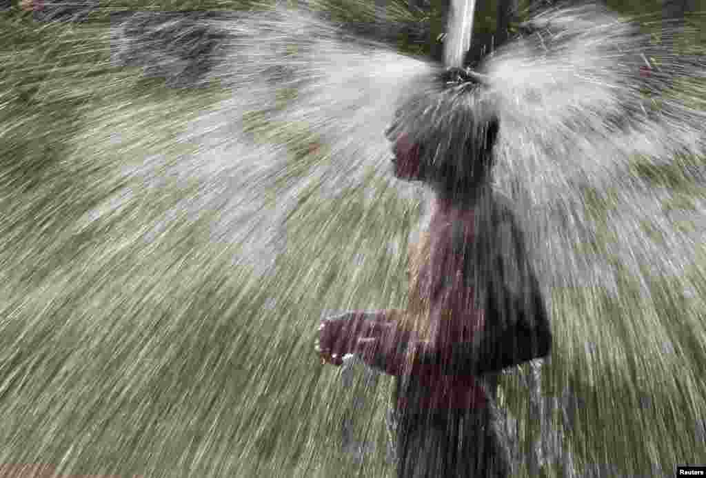 A man bathes in the waters of a tube well in the morning at Salamatpur village in the northern Indian state of Punjab.