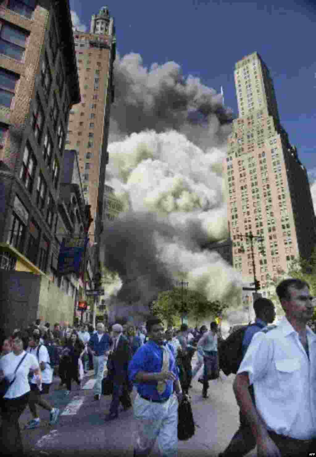 Pedestrians flee the area of the World Trade Center as the center's south tower collapses following a terrorist attack on the New York landmark Tuesday, Sept. 11, 2001. (AP Photo/Amy Sancetta) ITALY OUT