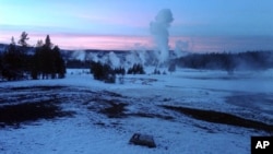 The Upper Geyser Basin at sunset in Yellowstone National Park, which extends across three western states: Wyoming, Montana and Idaho