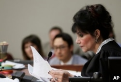 Judge Rosemarie Aquilina reads excerpts from the letter written by Larry Nassar during the seventh day of Nassar's sentencing hearing, Jan. 24, 2018, in Lansing, Mich. The former sports doctor admitted molesting some of the nation's top gymnasts for years.