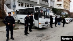 Riot police stand guard in front of a labor union office in Ankara, February 19, 2013. Police launched raids across Turkey early Tuesday targeting a militant leftist group behind a suicide bomb attack on the U.S. embassy.