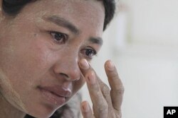 FILE - Burmese Ma Moe, who is infected with HIV, breaks into tears as she recalls how her husband died of AIDS. AIDS in Asia, has steadily worsened out of the spotlight, June 9, 2009.