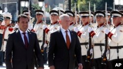 U.S. Defense Secretary James Mattis, center, and Macedonian Prime Minister Zoran Zaev walk past an honor guard at the government building in Skopje, Macedonia, Sept. 17, 2018. 