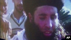 FILE - In this file image made from video broadcast on Thursday, Nov. 7, 2013, undated footage of Mullah Fazlullah is shown on a projector in Pakistan.