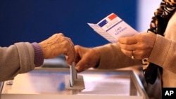 Voters cast their ballots in the regional elections, Dec. 13, 2015, in Nice, southeastern France.