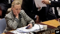 FILE - In this March 12, 2012, file photo, then-Secretary of State Hillary Clinton checks her mobile phone after her address to the Security Council at United Nations headquarters. The FBI released another batch of emails Oct. 21, 2016.