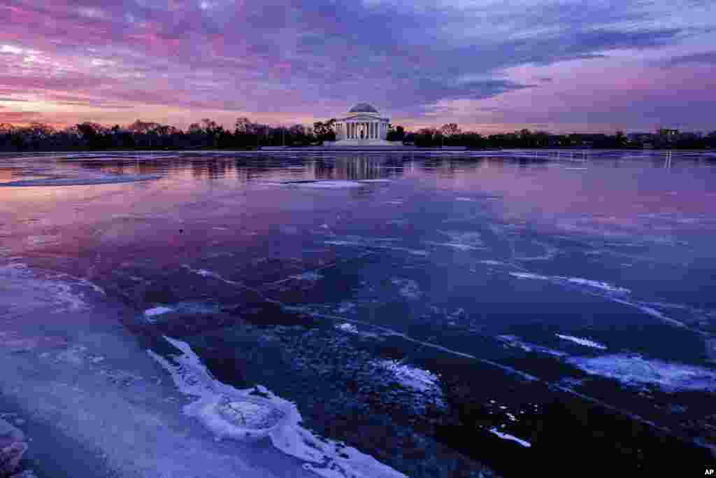 The Jefferson Memorial is reflected in the frozen Tidal Basin at daybreak in Washington.