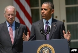 FILE - U.S. President Barack Obama, right, alongside Vice President Joe Biden, announces plans to reopen a U.S. Embassy in Havana, in the Rose Garden of the White House in Washington, July 1, 2015.