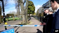 Britain's Prime Minister Theresa May is accompanied by Wiltshire Police Chief Constable Kier Pritchard and Salisbury MP John Glen, as she views the area where former Russian double agent Sergei Skripal and his daughter were found critically ill.