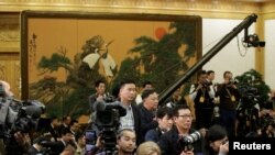 FILE - Journalists wait for a meeting before China's President Xi Jinping and other new Politburo Standing Committee members arrive at the Great Hall of the People in Beijing, Oct. 25, 2017.