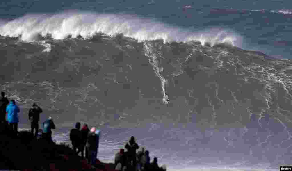 Big-wave surfer Sebastian Steudtner of Germany drops in a large wave at Praia do Norte in Nazare, Portugal.