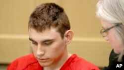 FILE - Nikolas Cruz, accused of killing 17 people at a Florida high school, appears in court for a status hearing in Fort Lauderdale, Florida., Feb. 19, 2018. Cruz was formally charged March 7 with 17 counts of premeditated murder and another 17 counts of attempted murder.