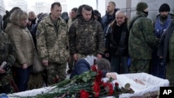 FILE - Fellow Ukrainian government soldiers and mourners bid farewell to Oleksandr Ilnitsky, who was shot dead by a pro-Russian rebel sniper in Ukraine's eastern Donetsk region, during a service in Kyiv's Independence Square, Jan. 11, 2016.