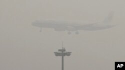 FILE - An Air China passenger plane prepares to land at the Beijing Capital International Airport as the capital of China through heavy smog on Wednesday, Dec. 21, 2016.
