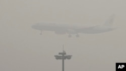 An Air China passenger plane prepares to land at the Beijing Capital International Airport as the capital of China through heavy smog on Wednesday, Dec. 21, 2016.