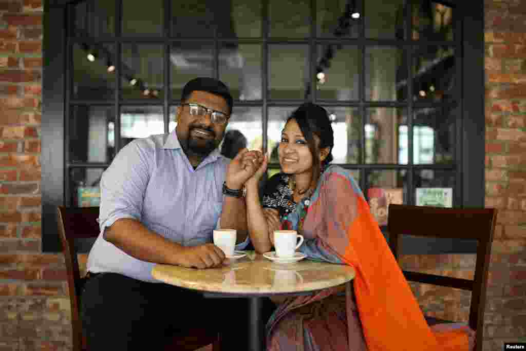 Mezbah Ul Aziz, left, 34, and Mausumi Iqbal, 33, pose for a photo in a coffee shop where they hang out on a regular basis in Dhaka, Bangladesh, Feb. 7, 2018. &quot;Our story was not love-at-first-sight type. ... but you know about magic, it always happens with surprises. Both of us are dentists and married for eight years now. Before that, we met at our dental school on June 1, 2004, on the first day of the class. We both were invited to give a short speech before our classmates and teachers. ... We never admitted, but maybe we felt some spark on the first day, but it was definitely not love. Later, we chose different paths. But fate brought us together after a year and a half. I was being bullied by some of my friends, then he came out of nowhere. He did not need to help me, but he did. From that day, we started our journey together. ... now, we have a treasure too, our five-year-old daughter, the center of our attraction, the sign of our love,&quot; Mausumi said.