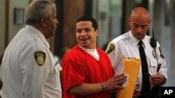 Eric Rivera, Jr. is moved to the courtroom holding room for the start of the fourth day of jury deliberation - and later found guilty - in the murder trial of Washington Redskins football star Sean Taylor, in Miami, Nov. 4, 2013.