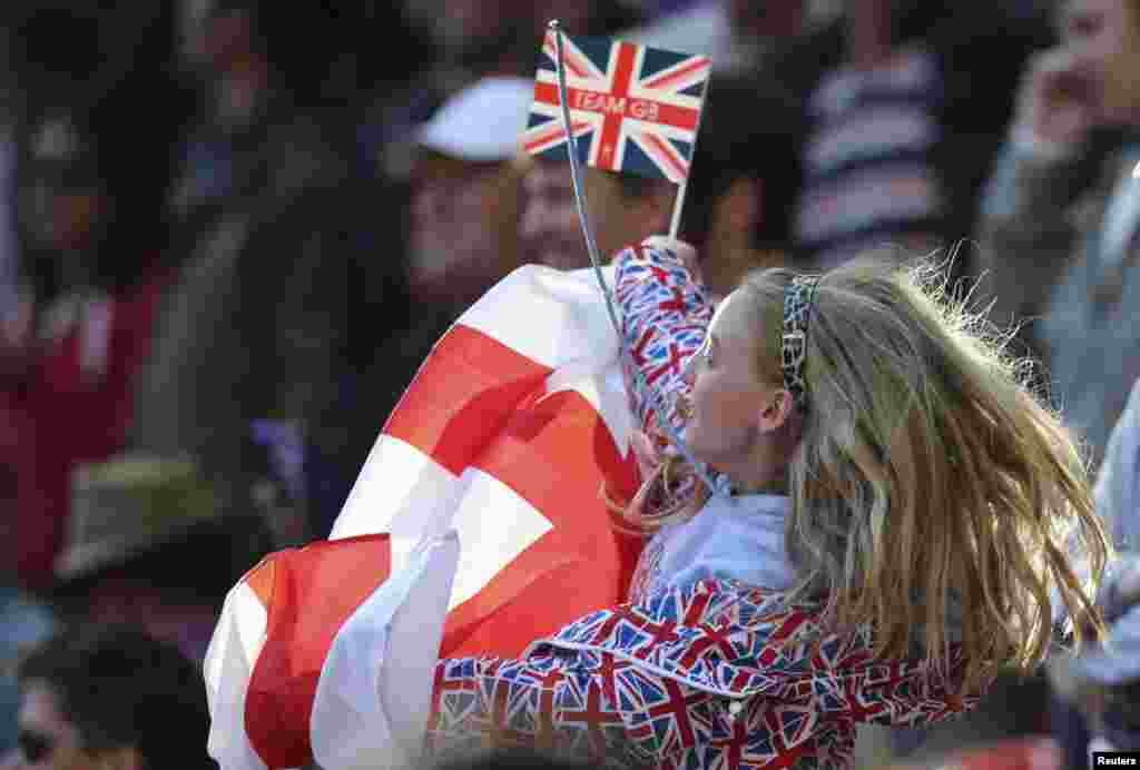 A Britain supporter waves before the men's preliminary first round Group A soccer match against UAE at the London 2012 Olympic Games in the Wembley Stadium in London.