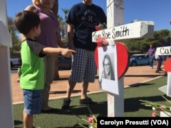 Parents brought their children to the memorial to see the crosses and honor the victims. The crosses honor the 59 people who died when a gunman opened fire on a country music concert, Oct. 1, 2017, in Las Vegas.