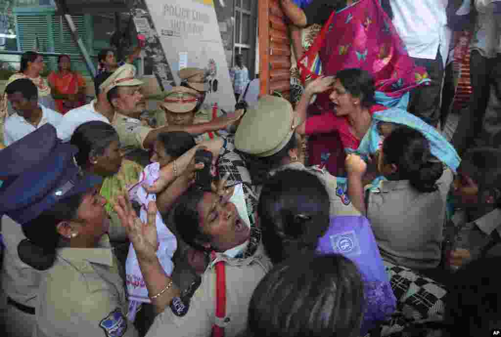 Indian police detain members of Centre of Indian Trade Unions protesting against the visit of U.S. President Donald Trump to India, in Hyderabad.