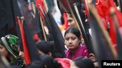 Garment workers take part in a rally against the deaths of their colleagues after a devastating fire in a garment factory in Dhaka, November 27, 2012.