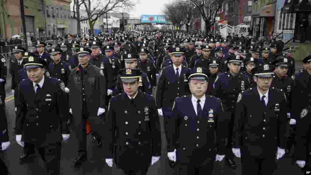Police officers arrive to the funeral of New York Police Department Officer Wenjian Liu at Aievoli Funeral Home, Jan. 4, 2015, in the Brooklyn borough of New York.