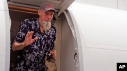 Former hostage Sjaak Rijke, released April 6 by an al-Qaida-related group, waves as he gets off an airplane in Bamako, Mali, April 7, 2015.