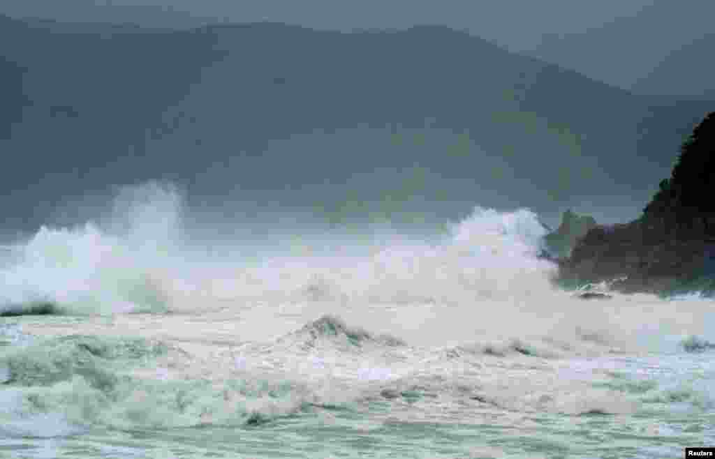 Waves crash as Typhoon Neoguri approaches the region at Wase beach at Amami Oshima, Kagoshima prefecture, in this photo taken by Kyodo, July 8, 2014. 