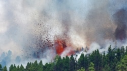 Lava and smoke rise following the eruption of a volcano in the Cumbre Vieja national park at El Paso, on the Canary Island of La Palma, September 19, 2021.