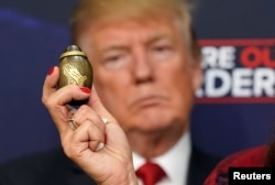 A woman holds an urn containing her son's remains as U.S. President Donald Trump holds an "Angel Families" meeting with victims of illegal immigration at the White House in Washington, June 22, 2018.