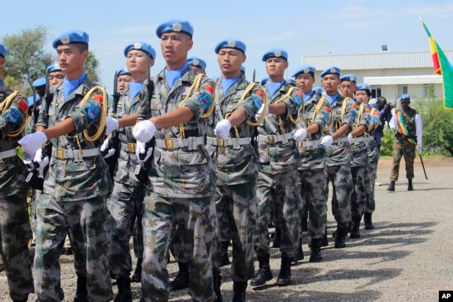 FILE - United Nations Chinese soldiers in the United Nations Mission to South Sudan march as they celebrate International Day of United Nations Peacekeepers, in Juba, May 29, 2017.