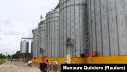 FILE - Workers walk in front of silos in the Hugo Chavez rice plant in Tucupita, Venezuela November 27, 2018. (REUTERS/Manaure Quintero )