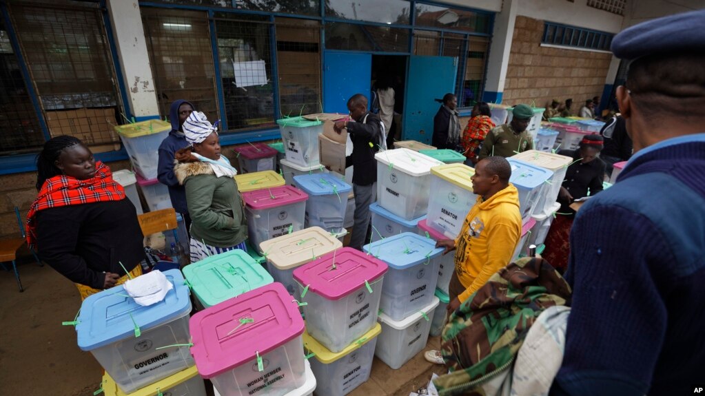 Electoral workers stand by ballot boxes stacked up at a collection center in Nairobi, Aug. 9, 2017. 