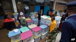 Electoral workers stand by ballot boxes stacked at a collection center in Nairobi, Kenya, Aug. 9, 2017. 